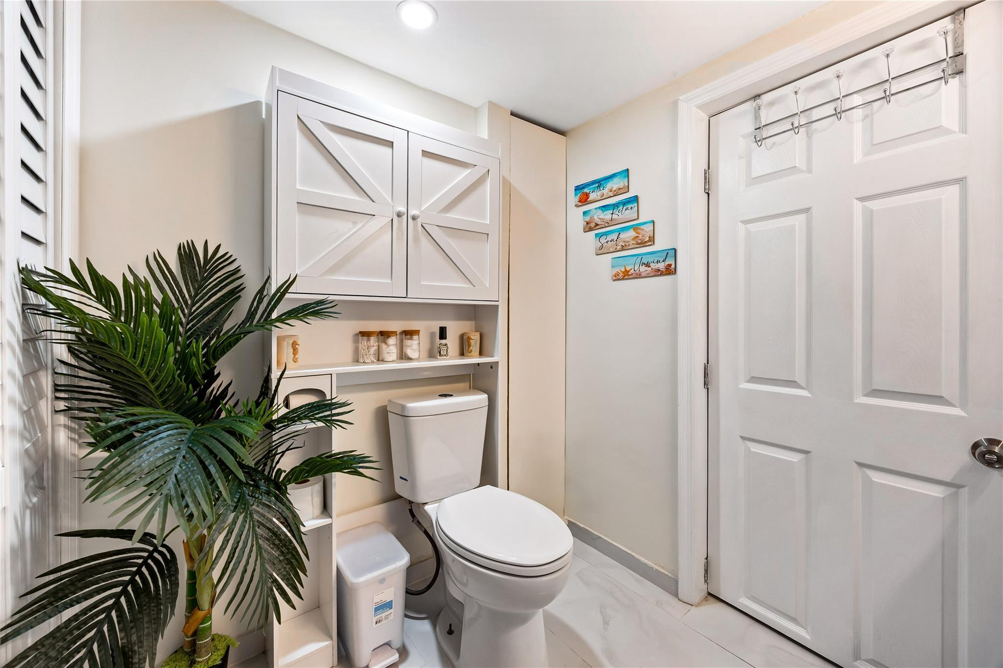218 Southwest 7th Street Dania Beach, FL 33004 - Photo 48 of 57 a white toilet sitting next to a bathroom and a sink