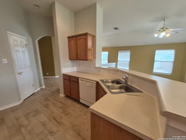 a kitchen with a sink a stove and cabinets