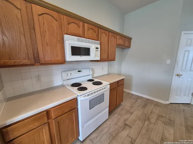 a kitchen with a stove and a microwave