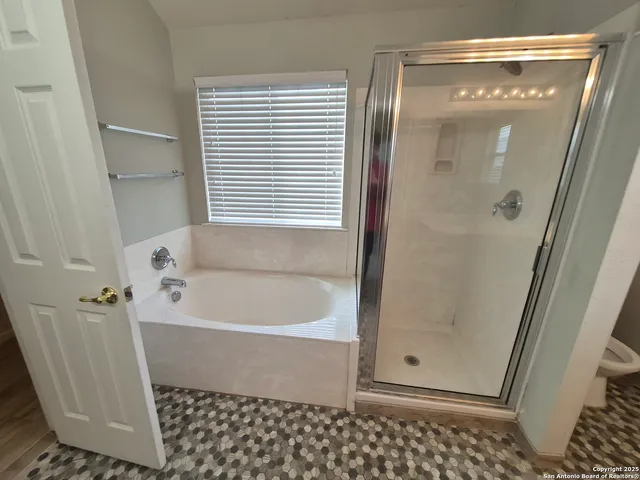 a bathroom with a bathtub and a shower