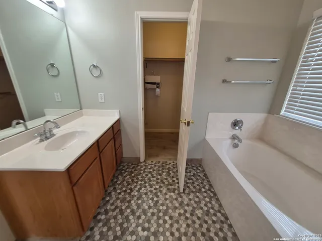 a bathroom with a double vanity sink a toilet and shower