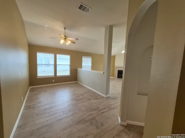 wooden floor in an empty room with a window