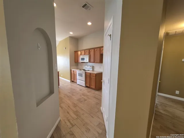 a view of a kitchen from the hallway