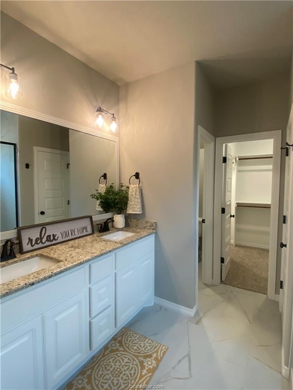 6434 Raleigh Drive College Station, TX 77845 - Photo 14 of 32 a bathroom with a double vanity sink and a mirror