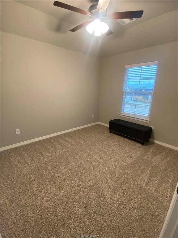 6434 Raleigh Drive College Station, TX 77845 - Photo 21 of 32 an empty room with a window and a ceiling fan