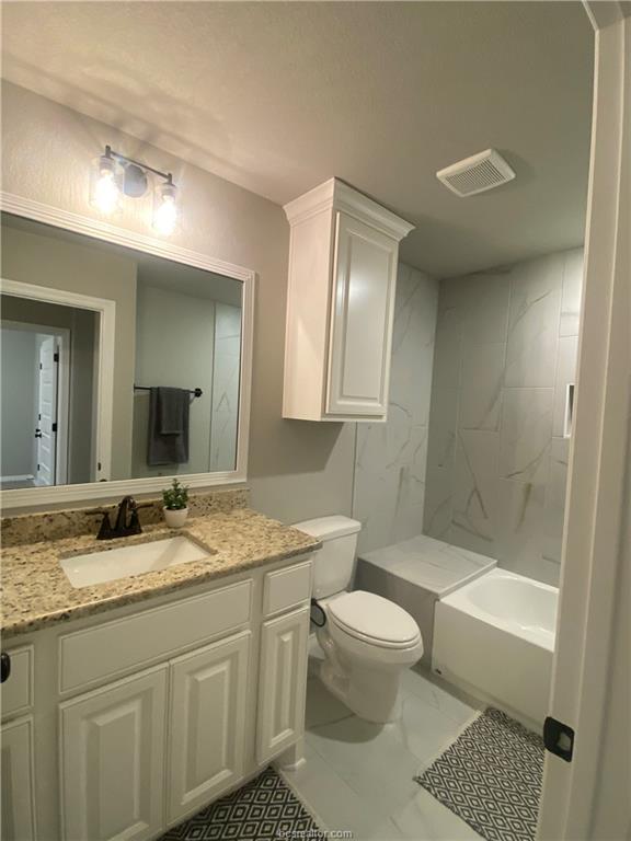 6434 Raleigh Drive College Station, TX 77845 - Photo 23 of 32 a bathroom with a granite countertop sink toilet mirror and shower