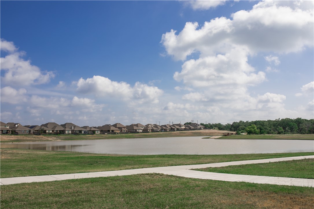6434 Raleigh Drive College Station, TX 77845 - Photo 32 of 32 a view of a lake with houses in the background