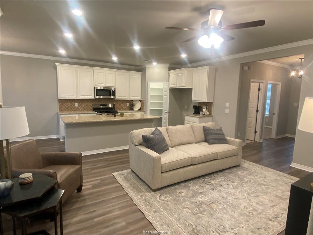 6434 Raleigh Drive College Station, TX 77845 - Photo 10 of 32 a view of a living room kitchen and a wooden floor