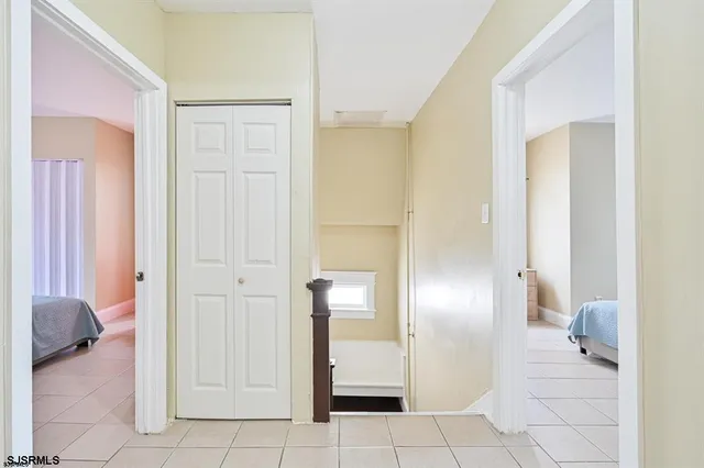 a view of a hallway with furniture and a livingroom