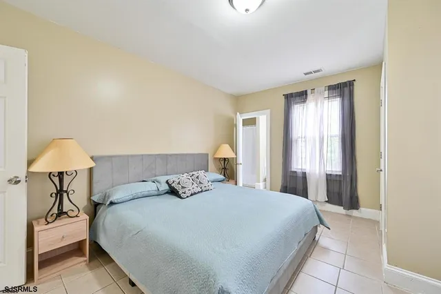 a bedroom with a bed and a lamp