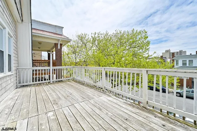 a view of a wooden deck with a yard