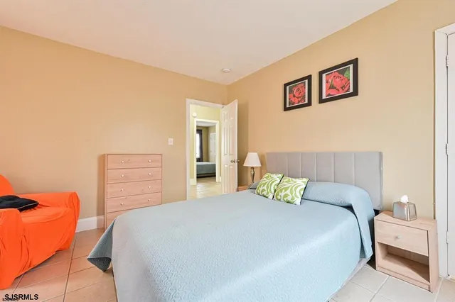 a bedroom with a bed and painting on the wall