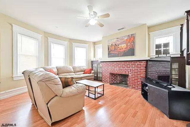 a living room with furniture and a fireplace