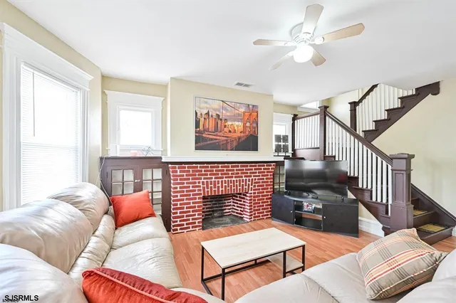a living room with furniture two lamp and a window