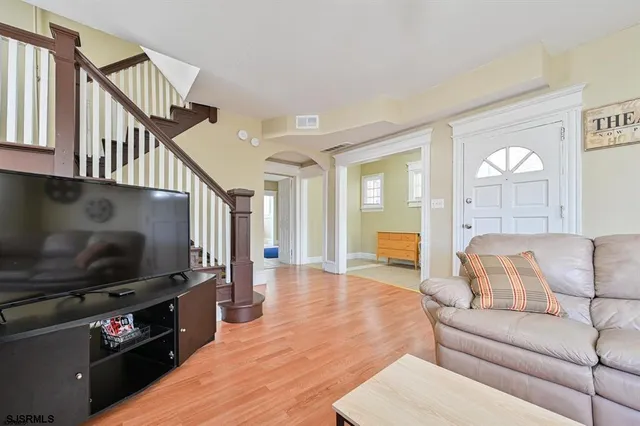 a living room with furniture and a flat screen tv