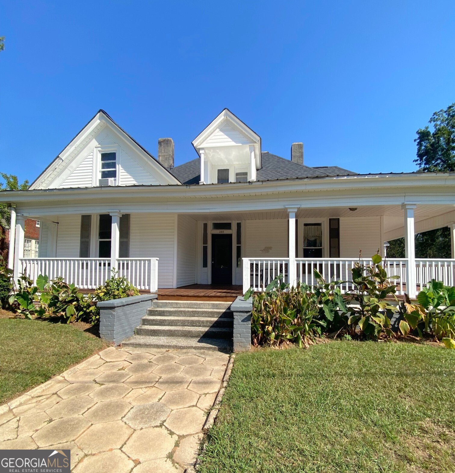 302 Cedar Street, Unit A Carrollton, GA 30117 - Photo 1 of 1 a front view of a house with garden