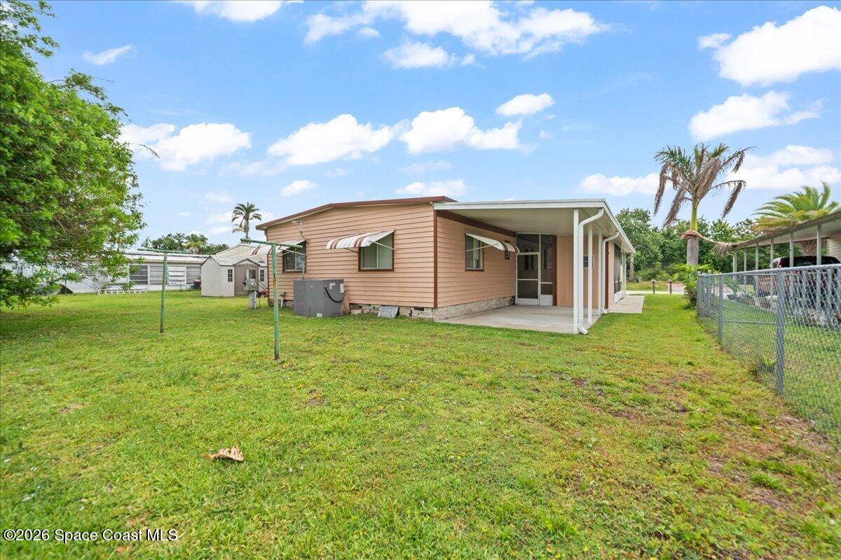 1740 Seagrape Street Northeast Palm Bay, FL 32905 - Photo 16 of 33 a backyard of a house with lots of green space