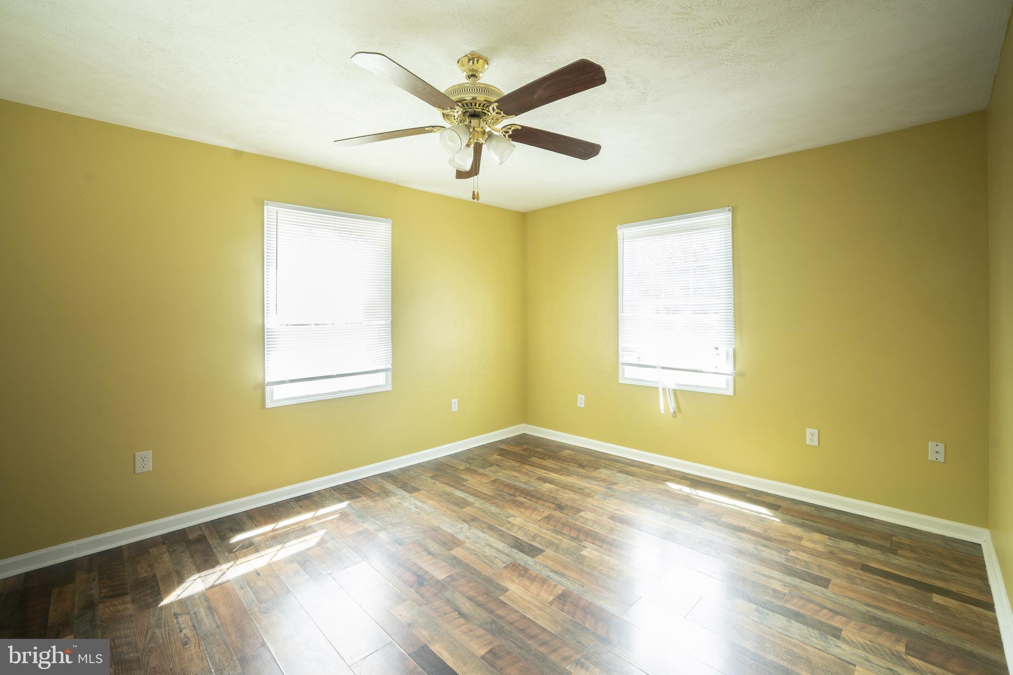 452 Acton Street Front Royal, VA 22630 - Photo 14 of 44 a view of an empty room with wooden floor and a window