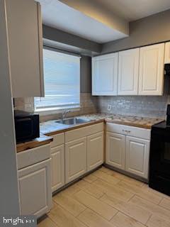 452 Acton Street Front Royal, VA 22630 - Photo 28 of 44 a kitchen with white cabinets and white appliances