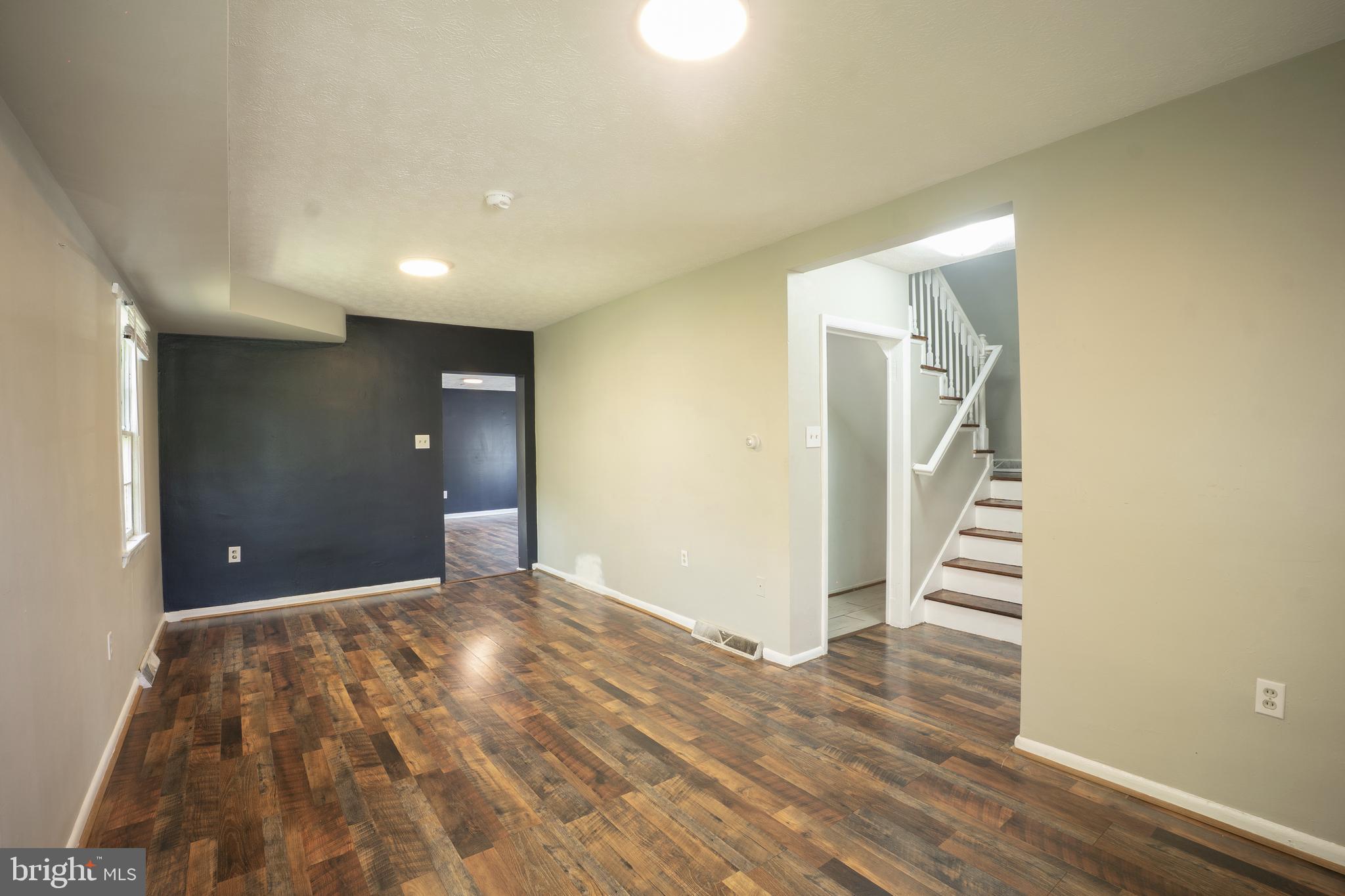 452 Acton Street Front Royal, VA 22630 - Photo 5 of 44 a view of a livingroom with wooden floor and stairs
