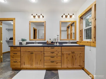 a bathroom with a sink and a large mirror