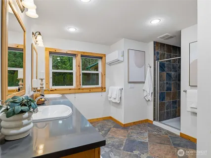 a bathroom with a tub and window