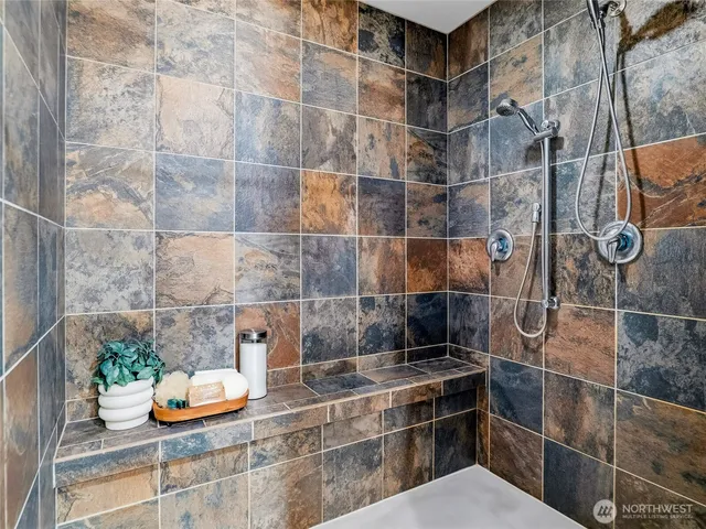 a bathroom with a granite countertop sink toilet and mirror