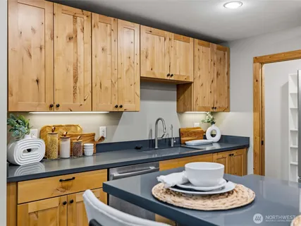 a kitchen with a stove a sink and cabinets