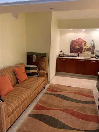 a living room with a couch and a floor to ceiling window