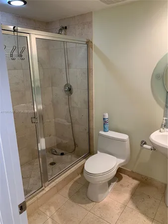 a white toilet sitting next to a bath tub