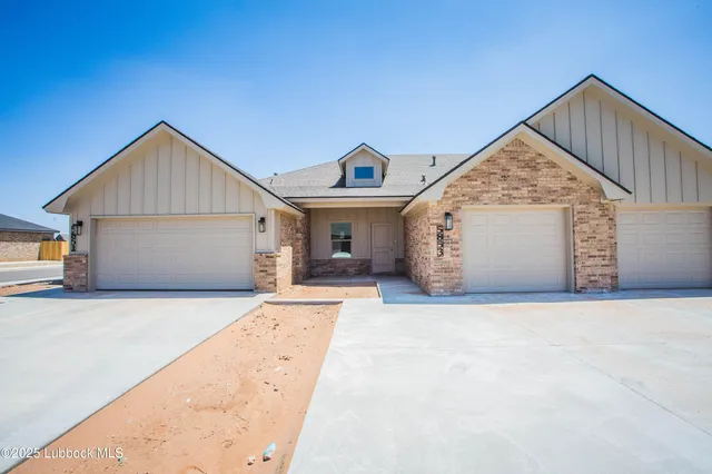 a view of a house with wooden floor and a garage