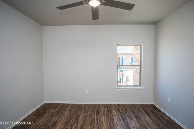 a bathroom with a granite countertop sink a toilet and a mirror
