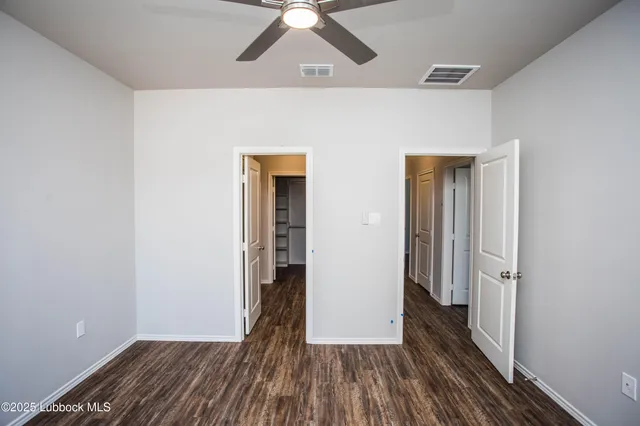 a bathroom with a granite countertop sink toilet and mirror