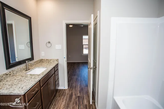 a kitchen with kitchen island granite countertop a sink and refrigerator