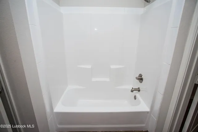 a kitchen with granite countertop kitchen island wooden cabinets and stainless steel appliances