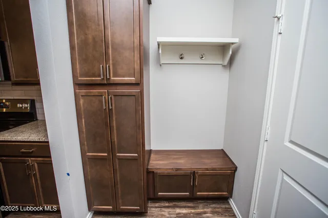 a view of a room with wooden floor