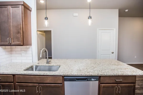 a bathroom with a granite countertop sink a toilet and mirror