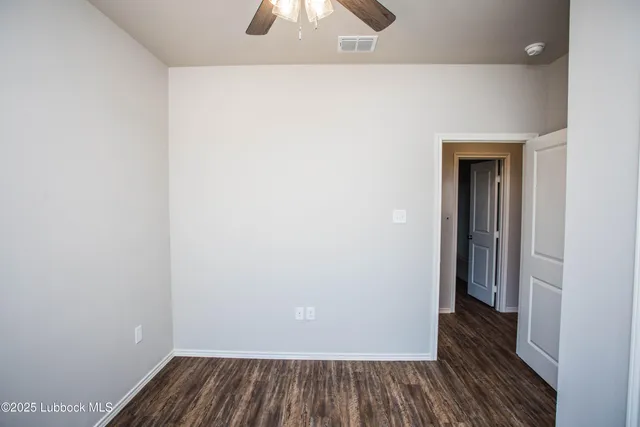 a view of a room with wooden floor and window