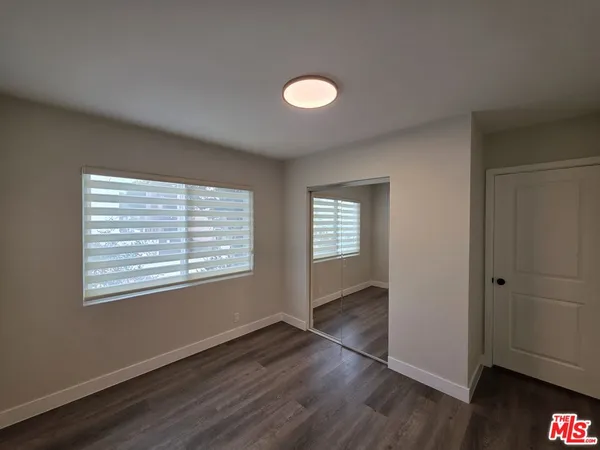 a view of an empty room and wooden floor