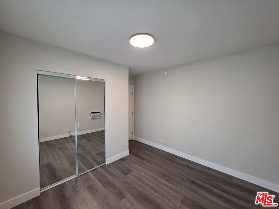 1411 Innes Place, Unit 1 Venice, CA 90291 - Photo 30 of 53 an empty room with wooden floor and sliding door