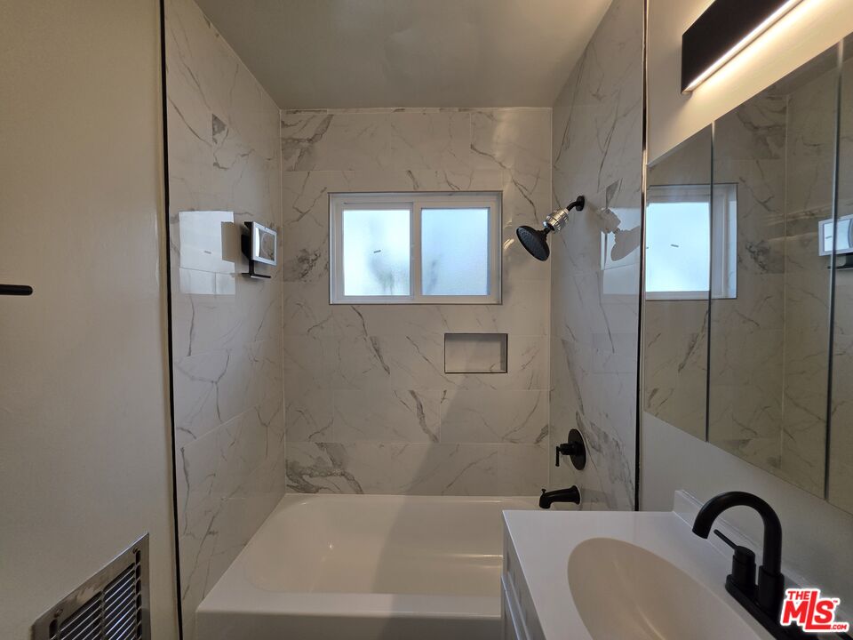 1411 Innes Place, Unit 1 Venice, CA 90291 - Photo 36 of 53 a bathroom with a granite countertop sink a toilet and shower