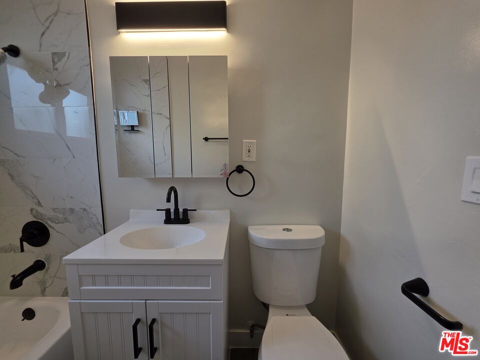 1411 Innes Place, Unit 1 Venice, CA 90291 - Photo 38 of 53 a bathroom with a toilet a sink and mirror