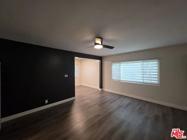 a kitchen with stainless steel appliances a stove top oven a refrigerator and a dining table