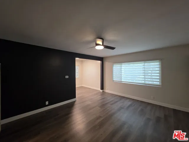 a kitchen with stainless steel appliances a stove top oven a refrigerator and a dining table