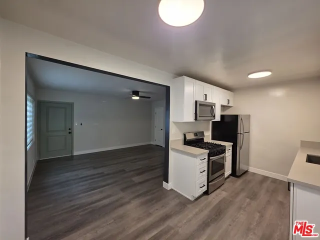 a kitchen with a sink stove and refrigerator