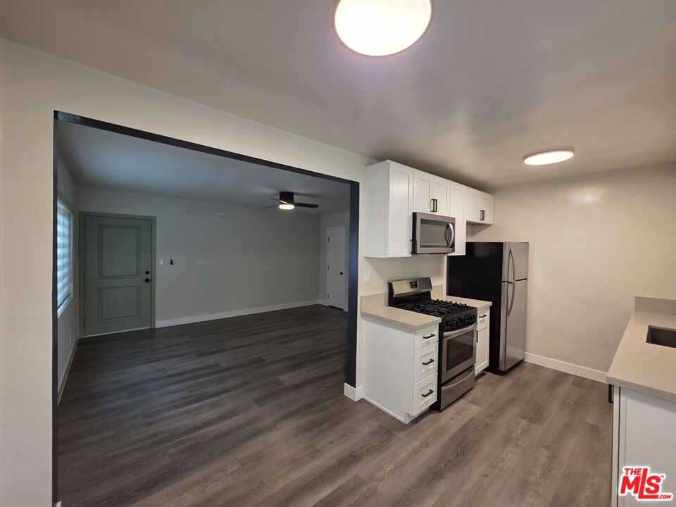 1411 Innes Place, Unit 1 Venice, CA 90291 - Photo 46 of 53 a kitchen with stainless steel appliances a stove top oven a refrigerator and a dining table