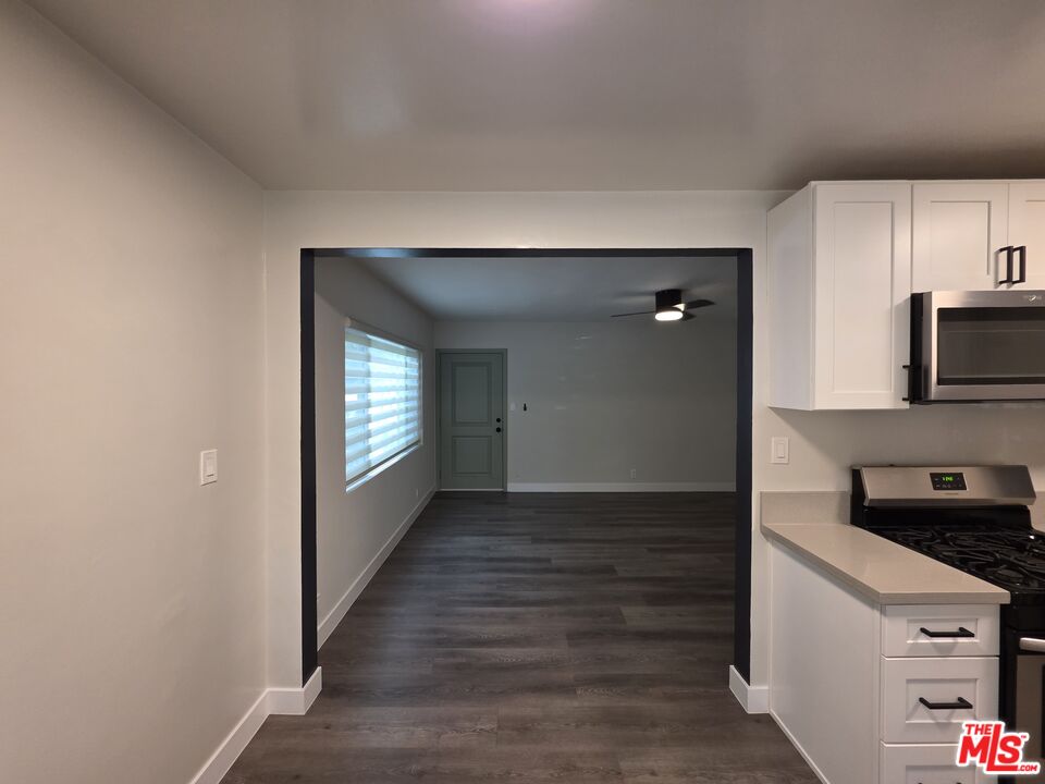 1411 Innes Place, Unit 1 Venice, CA 90291 - Photo 47 of 53 a view of an empty room and kitchen with wooden floor