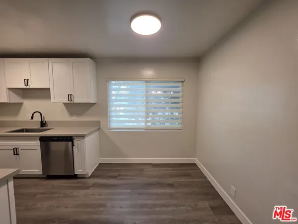 a kitchen with a stove a sink and a microwave