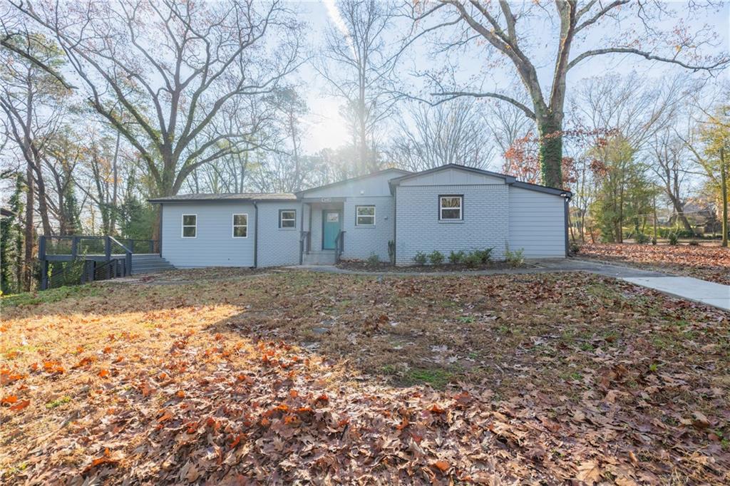 a view of a house with a yard covered with snow