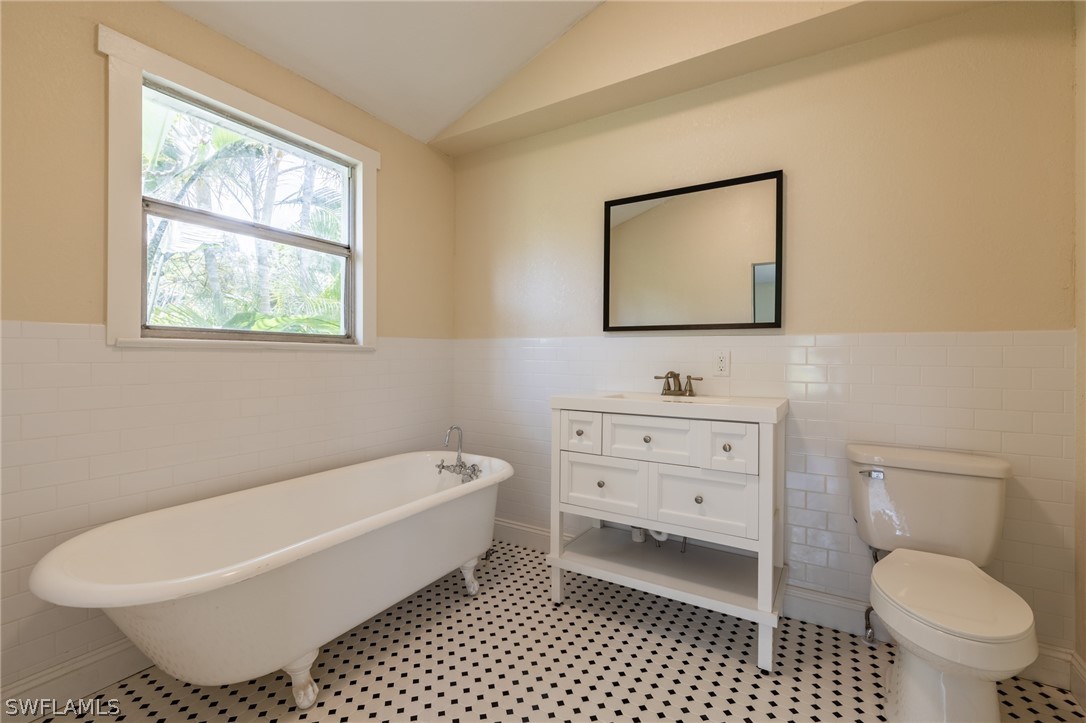1806 Coronado Road Fort Myers, FL 33901 - Photo 17 of 23 a bathroom with a toilet a sink and a window